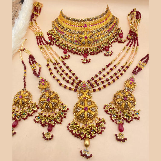 Regal Maroon Bridal Set Adorned with Fine Gold Detailing